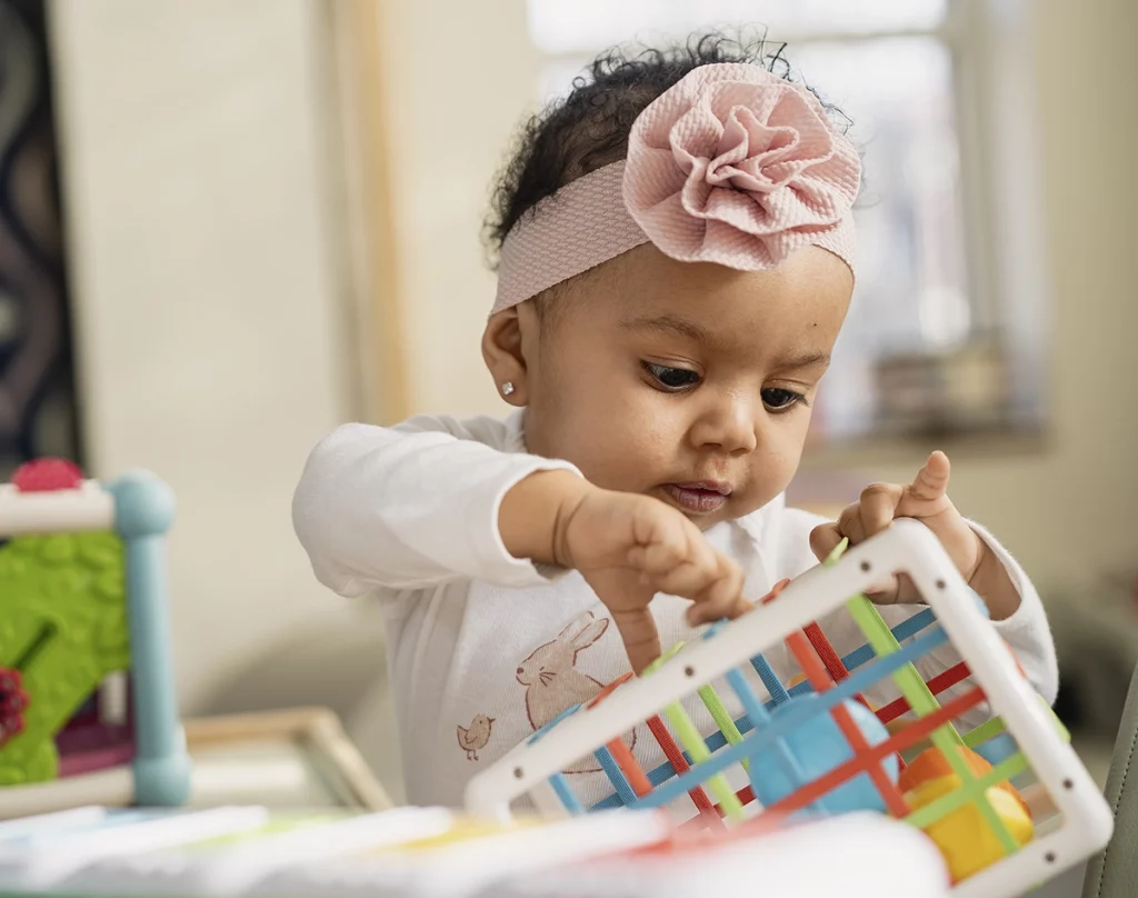 Photo of infant playing with a toy